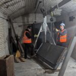 Workers using specialist lifting equipment to remove bank vault pieces